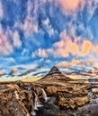 Spring sunrise over the famous Kirkjufellsfoss Waterfall with Kirkjufell mountain in the background in Iceland Royalty Free Stock Photo