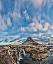 Spring sunrise over the famous Kirkjufellsfoss Waterfall with Kirkjufell mountain in the background in Iceland Royalty Free Stock Photo