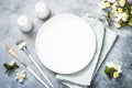 Spring Table setting with plate and flower top view. Royalty Free Stock Photo