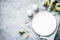 Spring Table setting with plate and flower top view. Royalty Free Stock Photo
