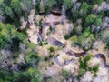 Spring taiga forest bird`s eye view stream and dry grass fallen trees