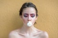 Spring teen woman with flower in mouth. Beauty, nature concept. Fashion look, makeup. Youth, flowering, blossom, bloom.