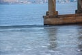 In the spring, a thin ice floe drifts downstream and floats past the bridge support