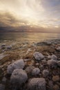 The spring thunder-storm. The coastal stones covered by salty adjournment Royalty Free Stock Photo