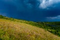 Spring thunderstorm in countryside. Dark blue cloudscape