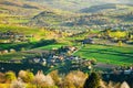 Spring time in beautiful agricultural landscape, green farm fields for animals and growing vegetables. Carpathian mountains, Royalty Free Stock Photo