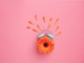 Spring time concept. Flat creative design: turquoise alarm clock with orange flower on dial with some of its petals detached on