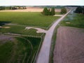 Spring time farmland fields and gravel road, aerial