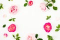 Spring time frame background. Floral composition of pastel pink roses flowers and green leaves on white background. Flat lay, top Royalty Free Stock Photo