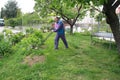 A man cutting grass to make nice lawn