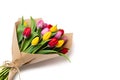 Spring tulip bouquet in pink, red and yellow with eco-friendly packaging on white background Royalty Free Stock Photo