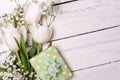 Spring tulip flowers, gift box and paper card on gray stone table from above in flat lay style. Greeting for Womens or Mothers Day Royalty Free Stock Photo