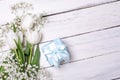 Spring tulip flowers, gift box and paper card on gray stone table from above in flat lay style. Greeting for Womens or Mothers Day Royalty Free Stock Photo