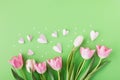 Spring tulip flowers with pink hearts on pastel background. Greeting card for International Women Day, Mother day. Royalty Free Stock Photo