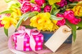 Spring flowers with gift box and empty tag Royalty Free Stock Photo