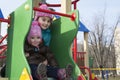 In the spring of two girls playing on the playground. Royalty Free Stock Photo