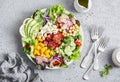 Spring vegetable salad with chickpeas, avocado and feta. Tasty healthy food. Buddha bowl. On a gray background