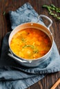 Spring vegetable soup with chicken stock in a pot on kitchen wooden table. Royalty Free Stock Photo