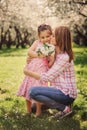 Spring vertical portrait of happy mother and kid daughter