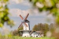 Spring view with blossoming fruit trees of a Dutch windmill in Deil, Gelderland Royalty Free Stock Photo