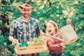 Spring village country. little girl and happy man dad. earth day. ecology. Watering can and shovel. family farm. father Royalty Free Stock Photo