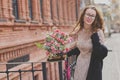 Spring walk of a girl with a flower bouquet Royalty Free Stock Photo