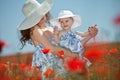 Young mother and her baby-girl in poppy field Royalty Free Stock Photo