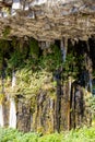 spring water flows along natural basalt columns