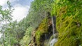 Spring of water in karstic rock, small waterfall in a green environment, Cuervo River source, Cuenca Royalty Free Stock Photo