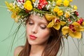 Spring Woman. Beauty Summer model girl with colorful flowers wreath and colorful hair. Flowers Hair Style. Royalty Free Stock Photo