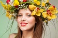 Spring Woman. Beauty Summer model girl with colorful flowers wreath and colorful hair. Flowers Hair Style. Royalty Free Stock Photo