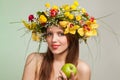 Spring Woman. Beauty Summer model girl with colorful flowers wreath and colorful hair. Flowers Hair Style. Royalty Free Stock Photo