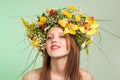 Spring Woman. Beauty Summer model girl with colorful flowers wreath and colorful hair. Flowers Hair Style. Royalty Free Stock Photo