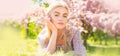 Spring woman face for banner. Beautiful girl in pink flowers in summer blossom park. Royalty Free Stock Photo