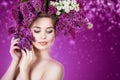 Spring woman portrait. Beauty girl with colorful wreath of lilac flowers in her hair Royalty Free Stock Photo