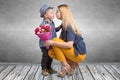 Small son gives his beloved mother a beautiful bouquet of pink roses and kisses mum . Spring,Women`s day,mother`s day. Royalty Free Stock Photo
