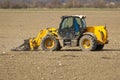 Spring work at farm. Farmer in tractor preparing the field for sowing. Farmer land and traktor Royalty Free Stock Photo