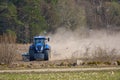 Spring work at farm. Farmer in tractor preparing the field for sowing. Farmer land and traktor