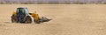 Spring work at farm. Farmer in tractor preparing the field for sowing. Farmer land and traktor Royalty Free Stock Photo