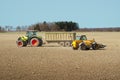 Spring work at farm. Farmer in tractor preparing the field for sowing. Farmer land and traktor