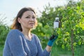 Spring work in the garden, bottle of chemical fertilizer, fungicide in hand