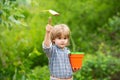 Spring work in the garden. Shovel and field tool. Little farmer. Organic farming.