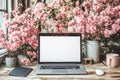 Spring workspace inspiration: blossoming productivity with cherry blossoms and tech setup Royalty Free Stock Photo