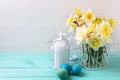 Spring yellow daffodils flowers and Easter eggs on turquoise wo Royalty Free Stock Photo