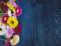 Spring yellow, pink and red gerbera flowers on blue wooden vintage background. Selective focus.Copy space and wide panoramic frame Royalty Free Stock Photo