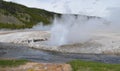 Spring in Yellowstone: Iron Spring Creek and Erupting Cliff Geyser of the Emerald Group in Black Sand Basin in Upper Geyser Basin