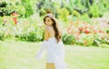 Spring young beautiful woman in summer fields being happy outdoors walking in field. Woman enjoy outdoor recreation