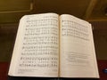 A hymnal openned up the hymn for the Sunday services Royalty Free Stock Photo