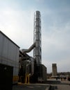 Stainless Steel Smokestack Against a Blue Sky