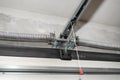 Springs tensioning the home garage door mechanism, view from the inside, visible rail with chain. Royalty Free Stock Photo